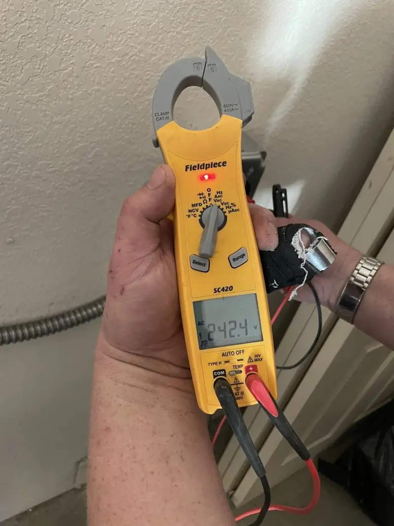 Voltage testing with clamp meter during Electrical Installation Services in Hollis